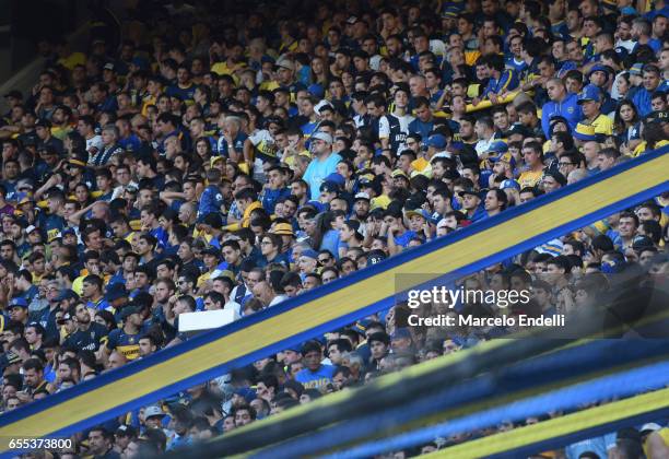 Fans of Boca Juniors cheer for their team during a match between Boca Juniors and Talleres as part of Torneo Primera Division 2016/17 at Alberto J...