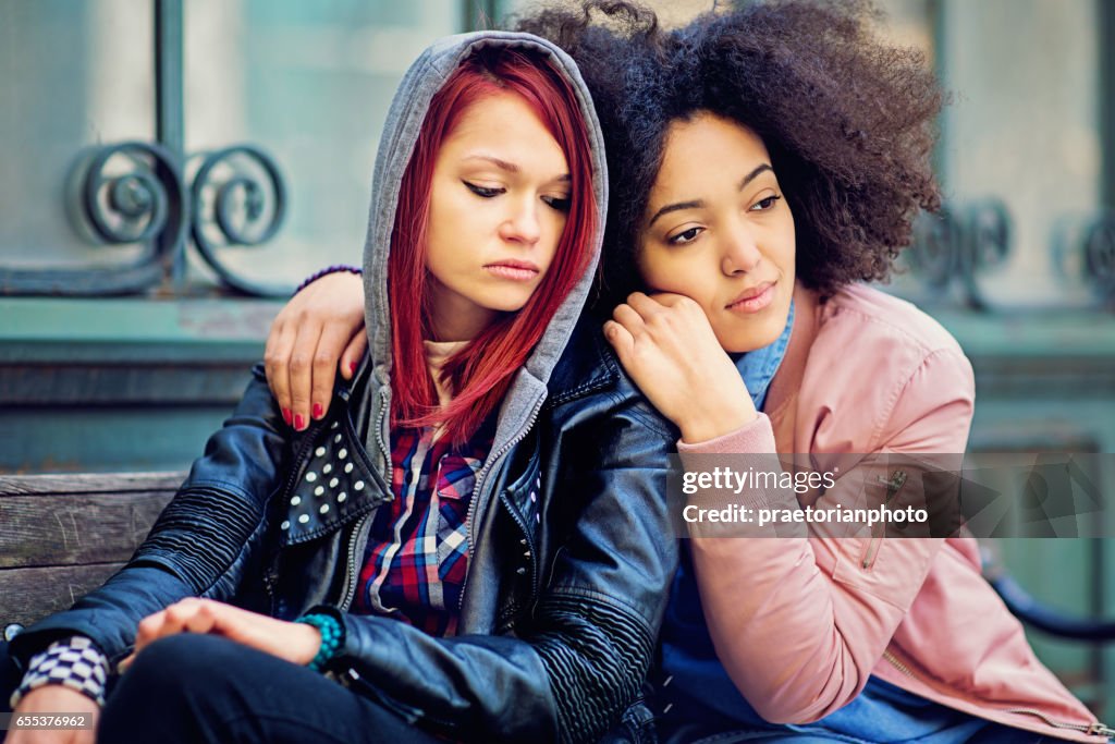 Girl is consoling her girlfriend after break up