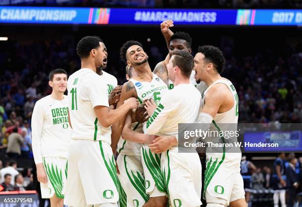 Tyler Dorsey of the Oregon Ducks celebrates with teammates after defeating the Rhode Island Rams 75-72 during the second round of the 2017 NCAA Men's...