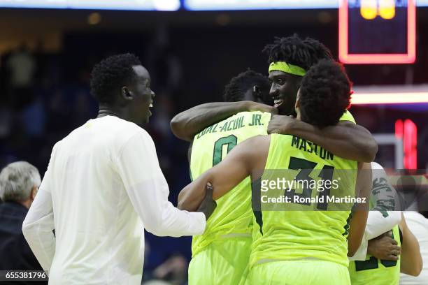 Johnathan Motley of the Baylor Bears celebrates with his teammates Terry Maston and Jo Lual-Acuil Jr. #0 after defeating the USC Trojans during the...