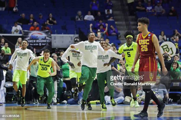 Bennie Boatwright of the USC Trojans reacts as the Baylor Bears celebrate their 82-78 victory over the USC Trojans during the second round of the...