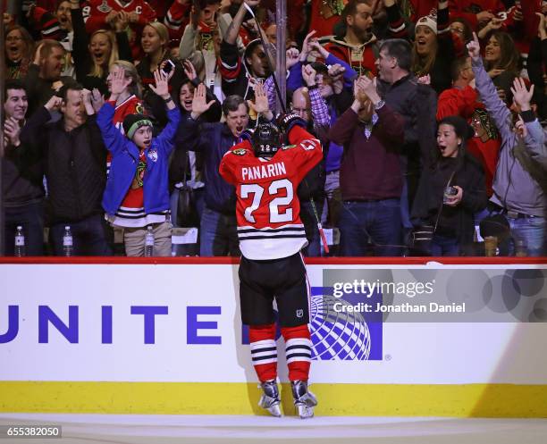 Fans cheer as Artemi Panarin of the Chicago Blackhawks celebrates a third period goal against the Colorado Avalanche at the United Center on March...