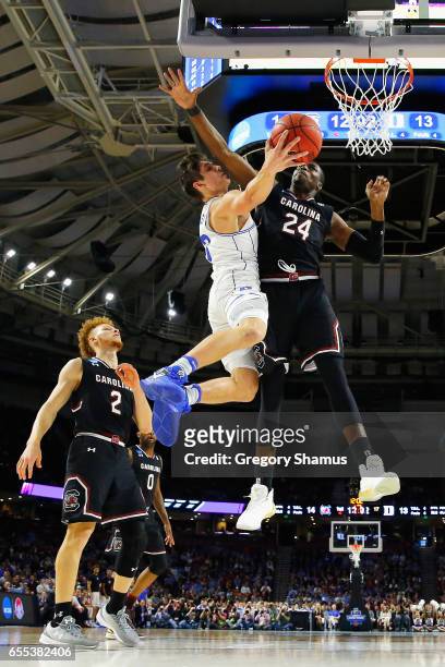 Sedee Keita of the South Carolina Gamecocks defends a shot by Grayson Allen of the Duke Blue Devils in the first half during the second round of the...