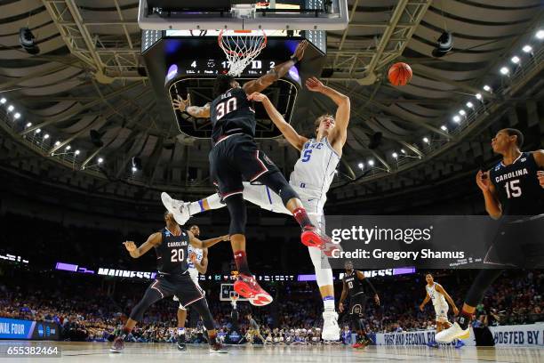 Luke Kennard of the Duke Blue Devils loses the ball as he drives to the basket against Chris Silva of the South Carolina Gamecocks in the first half...