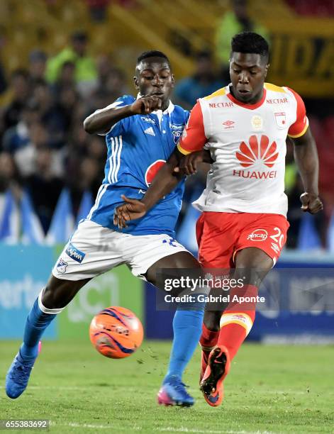 Deiver Machado of Millonarios struggles for the ball with Jose Adolfo Valencia of Santa Fe during the match between Millonarios and Independiente...