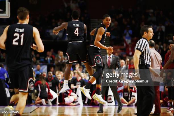 Rakym Felder and PJ Dozier of the South Carolina Gamecocks react in the second half against the Duke Blue Devils during the second round of the 2017...