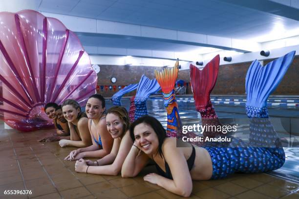 Women practice swimming with mermaid tails at AquaMermaid swimming school, a mermaid training school in Chicago, United States on March 19, 2017....