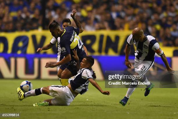 Oscar Benitez of Boca Juniors fights for the ball with Javier Gandolfi of Talleres during a match between Boca Juniors and Talleres as part of Torneo...