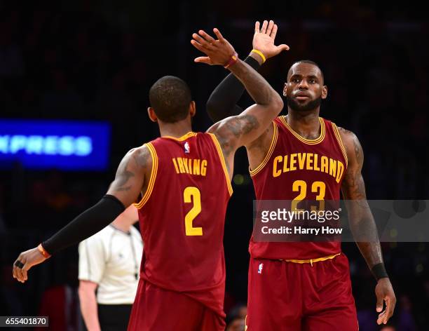 LeBron James of the Cleveland Cavaliers celebrates his basket with a foul with Kyrie Irving during a 125-120 win over the Los Angeles Lakers at...