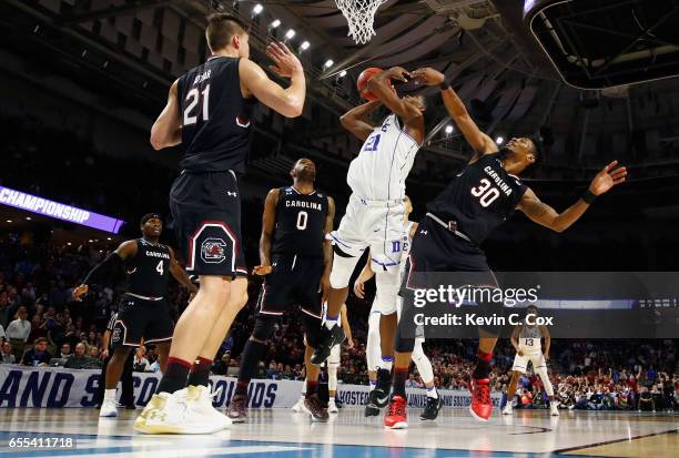 Chris Silva of the South Carolina Gamecocks defends Amile Jefferson of the Duke Blue Devils in the second half during the second round of the 2017...