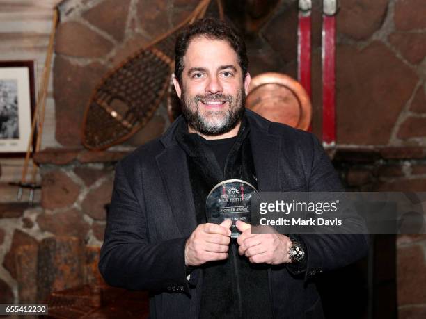 Film director Brett Ratner poses with the Sun Valley Film Festival 'Pioneer Award' on March 17, 2017 in Sun Valley, Idaho.