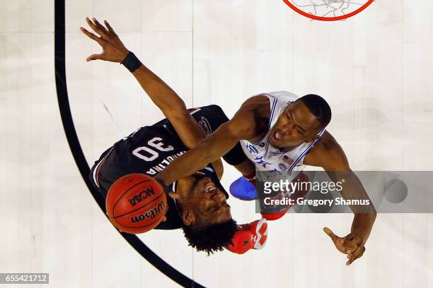 Chris Silva of the South Carolina Gamecocks and Harry Giles of the Duke Blue Devils battle for the ball in the second half during the second round of...