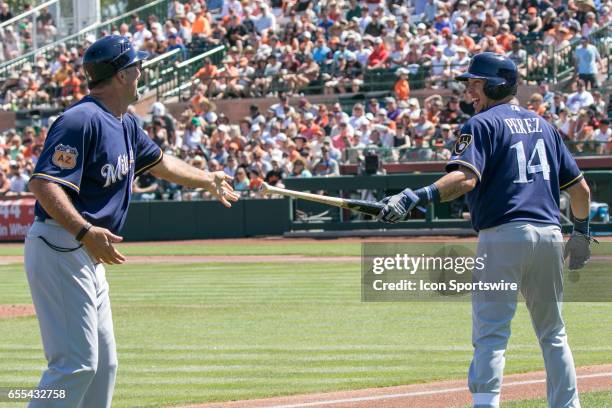 Milwaukee Brewers Second Baseman Hernan Perez laughs after losing the grip of his bat and tossing it down the third baseline as Milwaukee Brewers...