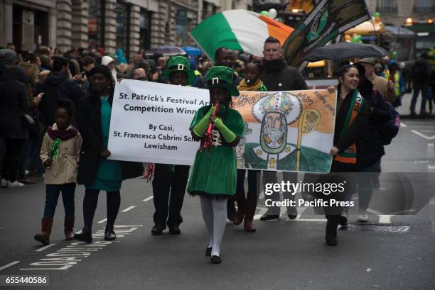 Girl wearing costume during the traditional St. Patricks Day parade, with flag bearers, elaborates floats and marching bands. The procession made its...