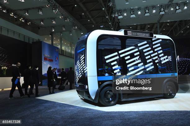 An International Business Machines Corp. Logo sits on the side of an 'Ollie' self-driving electric bus at the CeBIT 2017 tech fair in Hannover,...