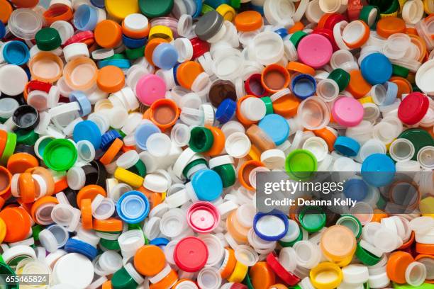 hundreds of colorful plastic bottle caps - bottle cap stock pictures, royalty-free photos & images