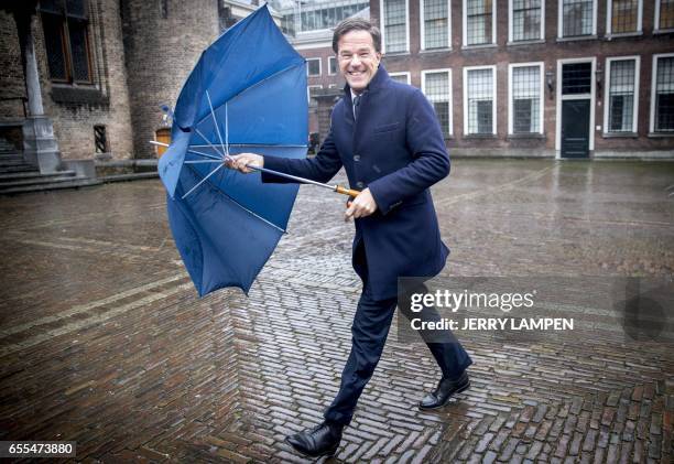 Newly re-elected Dutch Prime Minister Mark Rutte leader of the right-wing Liberal VVD, leaves following his meeting with Health Minister Edith...