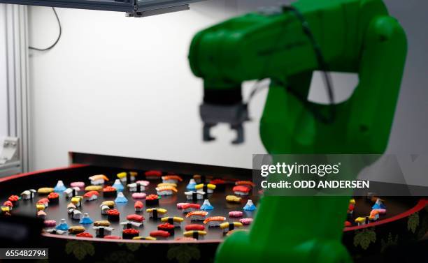 Robot made to pick up sushis is displayed at the CeBIT technology fair at its opening day on March 20, 2017 in Hanover, nothern Germany. German...
