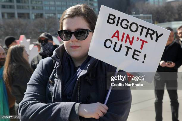 Protester holds a sign saying 'Bigotry Ain't Cute' during a counter-protest against Islamophobia and Fascism in downtown Toronto, Ontario, Canada, on...
