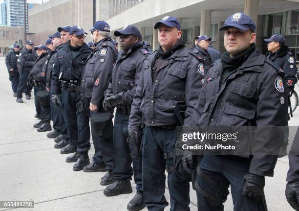 Police stand guard during a counter-protest against Islamophobia and Fascism in downtown Toronto, Ontario, Canada, on March 19, 2017. Protesters...