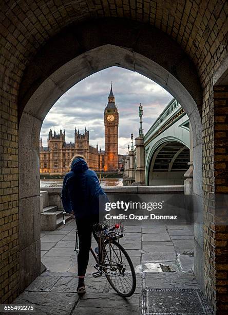 Woman riding bicycle by The River Thames