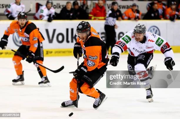 Mark Voakes of Wolfsburg and Alexandre Bolduc of Koeln battle for the puck during the DEL Playoffs quarter finals Game 4 between Grizzlya Wolfsburg...