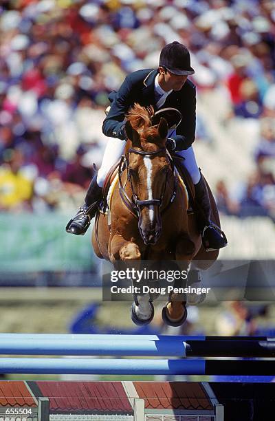 Rodrigo Pessoa of Brazil riding Baloubet Du Rouet jumps over the fence during the Individual Jumping Event in the 2000 Sydney Olympics at the Sydney...