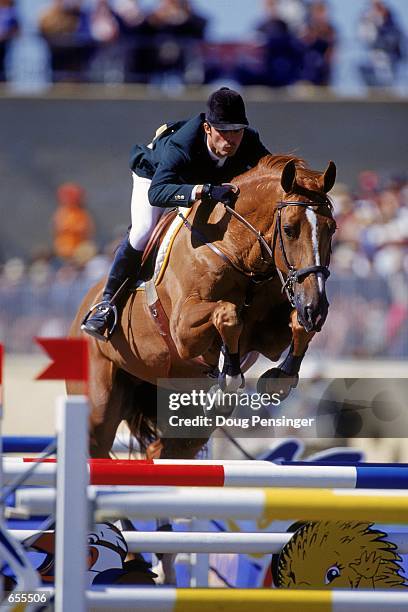 Rodrigo Pessoa of Brazil riding Baloubet Du Rouet jumps over the fence during the Individual Jumping Event in the 2000 Sydney Olympics at the Sydney...