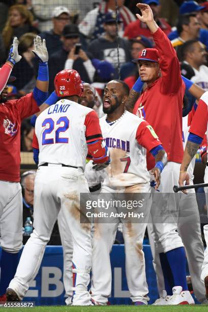 Robinson Cano clebrates with Jose Reyes and teammates of Team Dominican Republic after hitting a solo home run in the bottom of the seventh inning of...