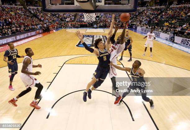 Mangok Mathiang of the Louisville Cardinals shoots the ball against the Michigan Wolverines during the second round of the NCAA Basketball Tournament...