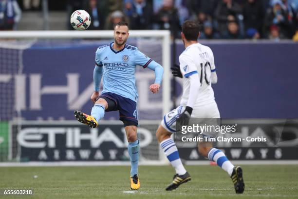 March 18: Maxime Chanot of New York City FC clears while challenged by Ignacio Piatti of Montreal Impact during the New York City FC Vs Montreal...
