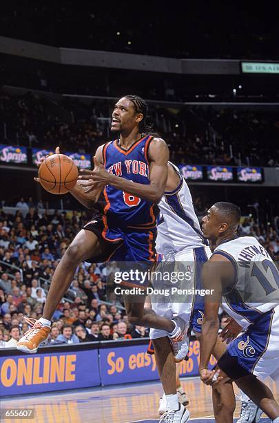 Latrell Sprewell of the New York Knicks makes a layup as he is guarded by Chris Whitney of the Washington Wizards at the MCI Center in Washingotn,...