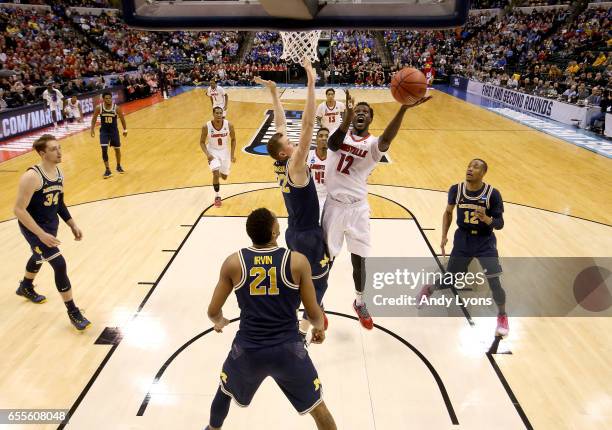 Mangok Mathiang of the Louisville Cardinals shoots the ball against the Michigan Wolverines during the second round of the NCAA Basketball Tournament...