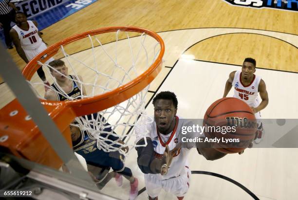 Mangok Mathiang of the Louisville Cardinals shoots the ball against the Michigan Wolverines during the second round of the NCAA Basketball Tournament...