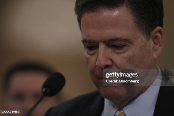 James Comey, director of the Federal Bureau of Investigation , pauses while speaking during a House Intelligence Committee hearing in Washington,...