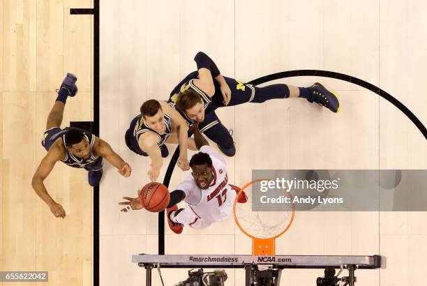 Mangok Mathiang of the Louisville Cardinals shoots the ball against the Michigan Wolverines during the second round of the NCAA Basketball Tournament...
