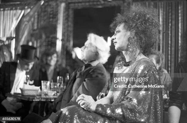 Quentin Crisp , center, and Holly Woodlawn , right, at an event in June 1988 in New York City, New York.