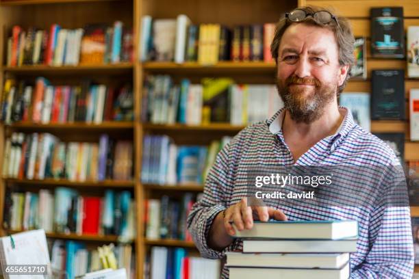 shopkeeper working in a traditional english bookshop - book shop stock pictures, royalty-free photos & images