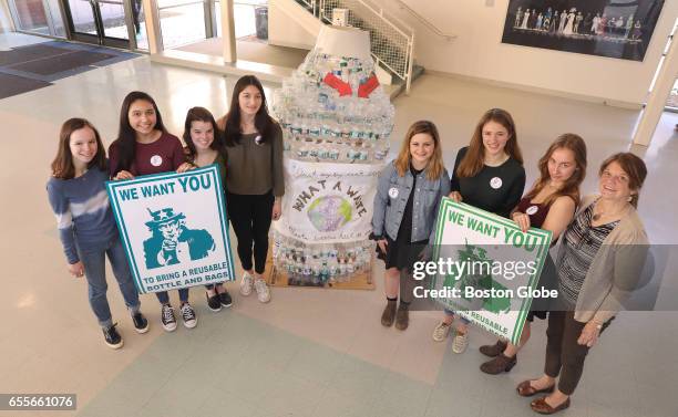 Students in the Environmental Club at Lincoln-Sudbury Regional High School in Sudbury, MA pose with a water-bottle sculpture that was made in the...