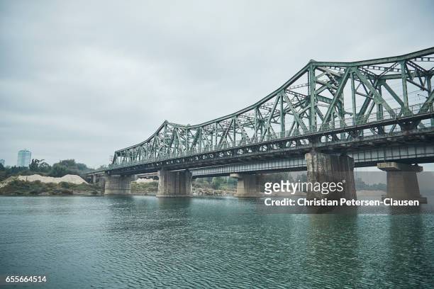 old bridge crossing taedong river - taedong river stock pictures, royalty-free photos & images