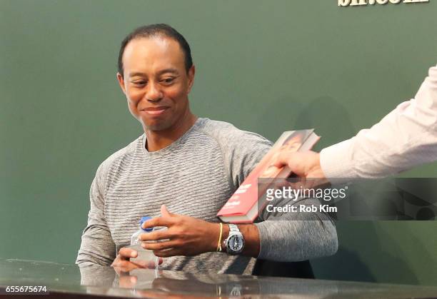 Tiger Woods signs copies of his new book, "The 1997 Masters: My Story" at Barnes & Noble Union Square on March 20, 2017 in New York City.