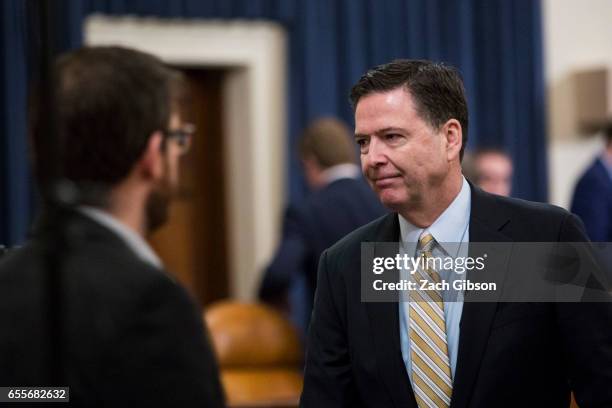 James Comey, Director of the Federal Bureau of Investigation , leaves the room for a break during a House Permanent Select Committee on Intelligence...