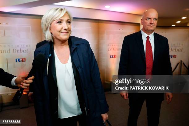 French presidential election candidate for the far-right Front National party Marine Le Pen , next to her bodyguard Thierry Legier , arrives for a...