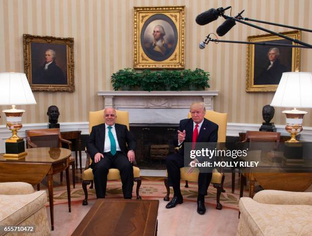 President Donald Trump meets with Iraqi Prime Minister Haider Al-Abadi in the Oval Office in the White House on March 20 in Washington, DC. / AFP...