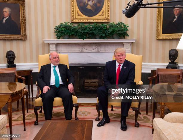 President Donald Trump meets with Iraqi Prime Minister Haider Al-Abadi in the Oval Office in the White House on March 20 in Washington, DC. / AFP...