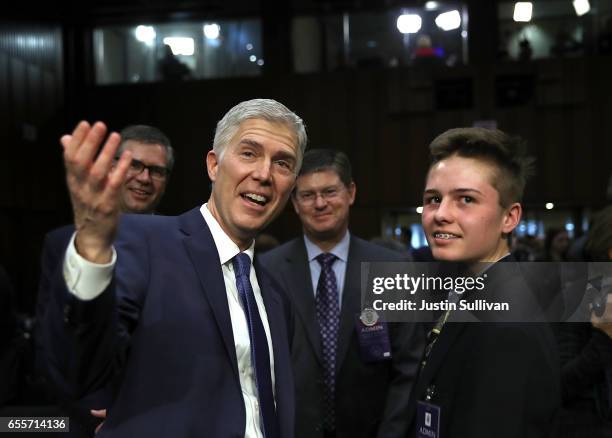 Judge Neil Gorsuch gestures at photographers during the first day of his Supreme Court confirmation hearing before the Senate Judiciary Committee in...