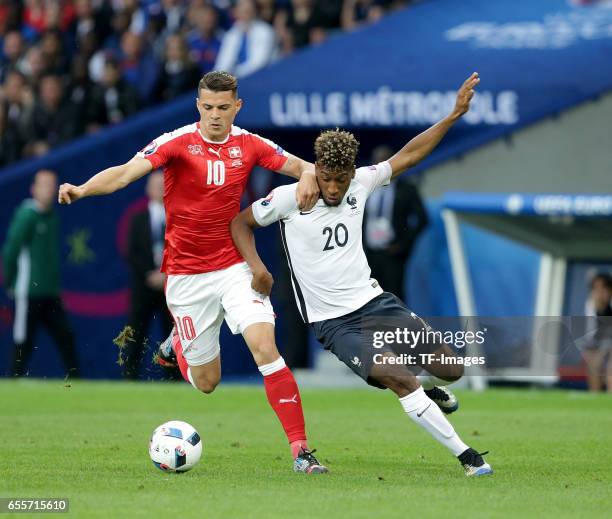 Granit Xhaka of Switzerland and Kingsley Coman of France battle for the ball during the UEFA Euro 2016 Group A match between the Switzerland and...
