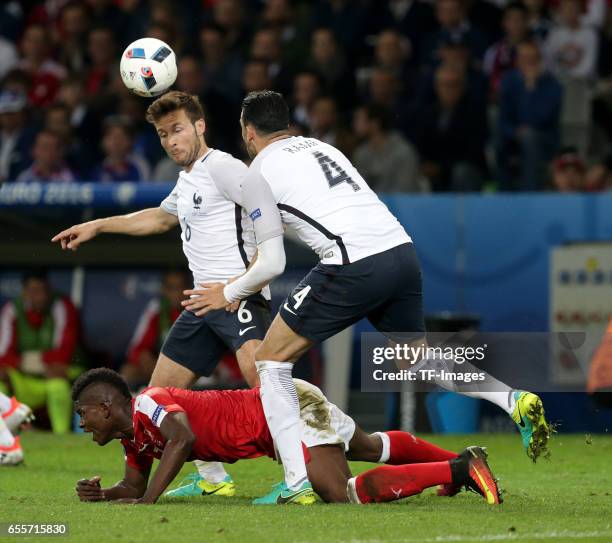 Yohan Cabaye of France and Breel Embolo of Switzerland and Adil Rami of France battle for the ball during the UEFA Euro 2016 Group A match between...