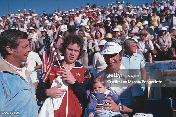 American tennis players John McEnroe and Stan Smith pictured with captain Tony Trabert as they prepare to compete for the United States team against...