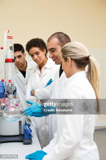 students and teacher conducting scientific experiment - laboratory shaker stock pictures, royalty-free photos & images